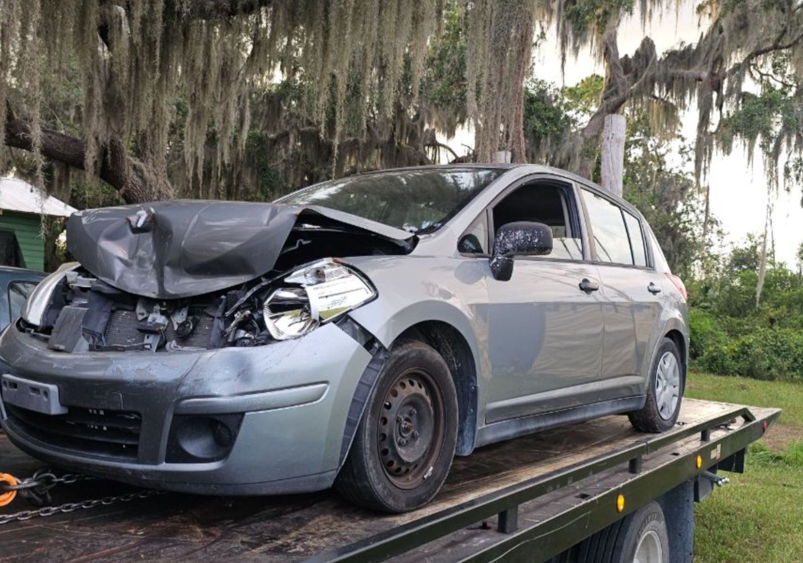 Damaged gray car loaded for junk car removal in Deltona, FL