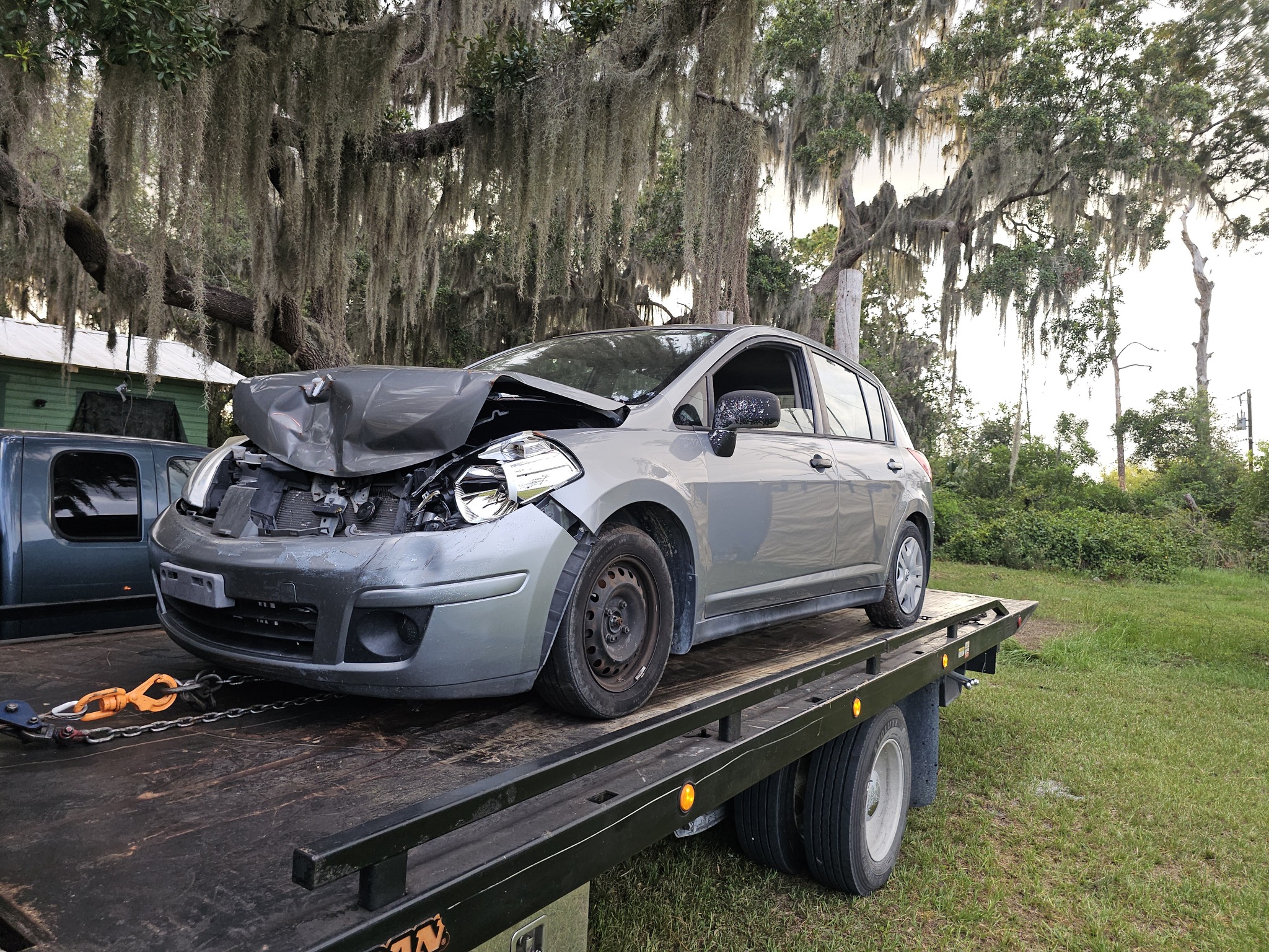 Damaged gray car loaded for junk car removal in Deltona, FL