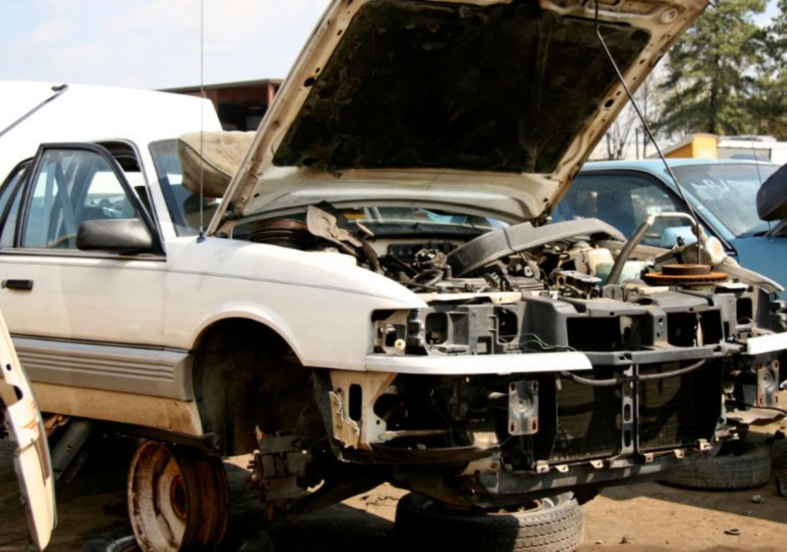 White non-running vehicle prepared for junk car pickup in Deltona, FL